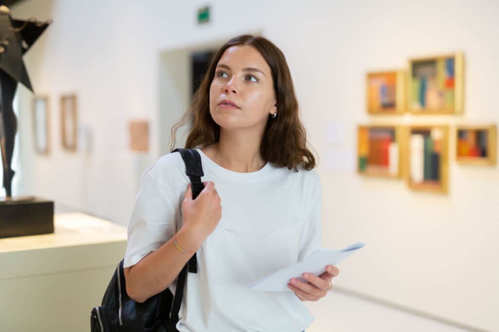 A woman admiring paintings at the Millennium Art Gallery