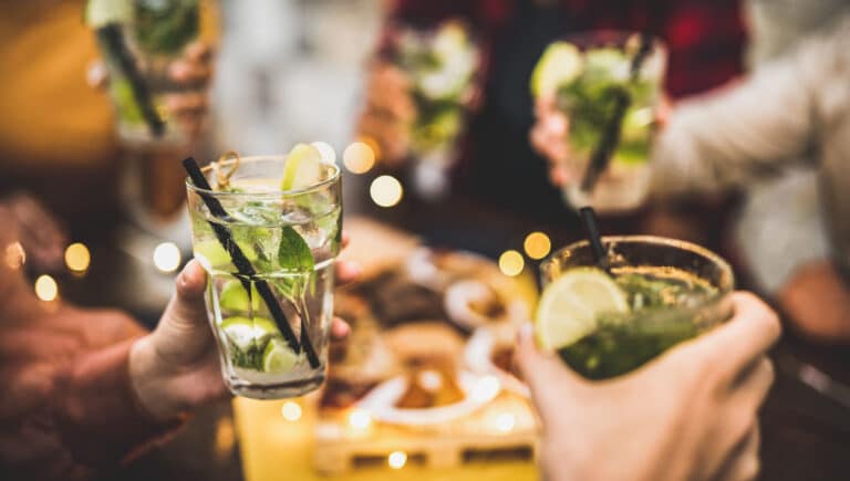 People holding mojito drinks